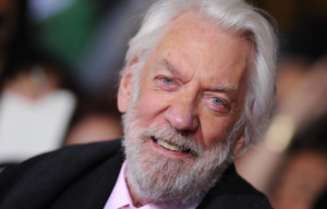 Donald Sutherland standing on a red carpet